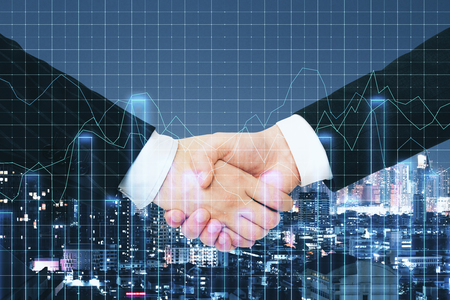 Side view and close up of handshake on glowing night city background with forex chart. Teamwork and investment concept. Double exposureの写真素材