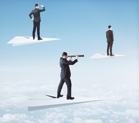 Businessmen on white paper planes looking into the distance with telescopes on sky background. Future and research conceptの写真素材