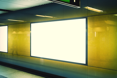 Side view of clean white subway billboard on orange wall. Advertisement and urban concept. Mock upの写真素材