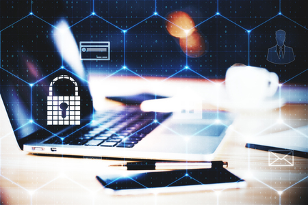 Laptop with glowing padlock interface on desk with blurry items. Security and safety concept. Double exposureの写真素材