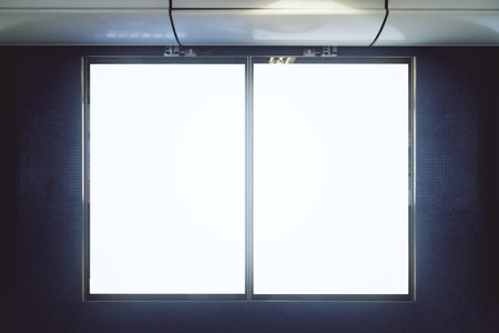 Front view of empty white underground banner on gray wall. Advertisement and urban concept. Mock upの写真素材