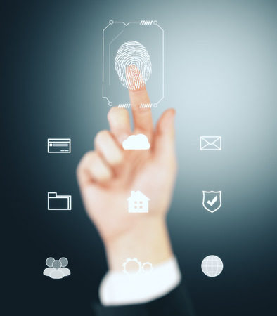 Fingerprint scan provides security access with biometrics identification, person touching screen on gray background. Id and verification conceptの写真素材