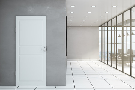 Modern office corridor interior with furniture, white door and window with panoramic city and sky view. Design concept. 3D Renderingの写真素材