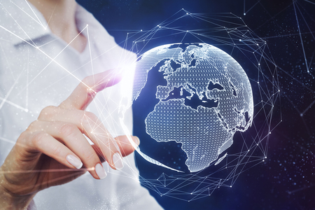 Close up of hand using abstract globe hologram on blurry background. Cyberspace and world concept.の写真素材