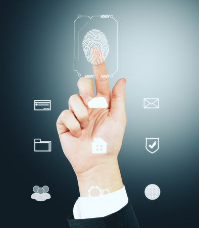 Fingerprint scan provides security access with biometrics identification, person touching screen on gray background. Id and data conceptの写真素材
