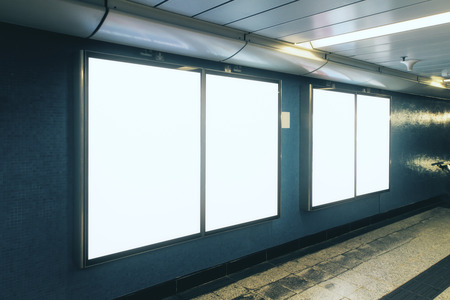 Side view of empty white subway poster on gray wall. Advertisement and urban concept. Mock up の写真素材