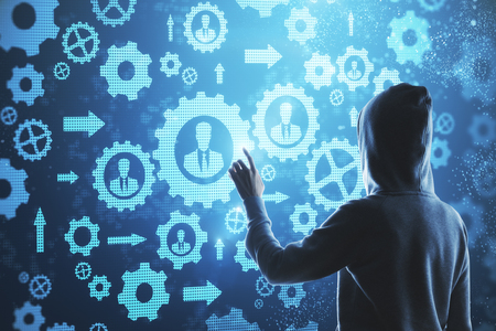 Hacking using abstract digital blue cogwheel interface. Hacking and industry concept.の写真素材