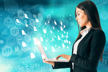 Side view of attractive young european adult using laptop on abstract blue background with digital interface. Innovation and hud conceptの写真素材