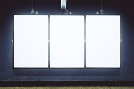 Front view of empty white underground poster on gray wall. Advertisement and urban concept. Mock upの写真素材