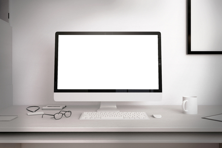 Modern desktop with empty white computer screen in modern office interior. Design and ad concept. Mock up, 3D Renderingの写真素材