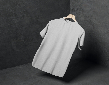 Abstract levitating grey t-shirt on hanger in concrete corner with shadow. Store, fabric, fashion and mockup concept. 3D Renderingの写真素材