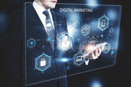 Young businessman using smartphone with digital business interface. Marketing and innovation concept. Double exposureの写真素材