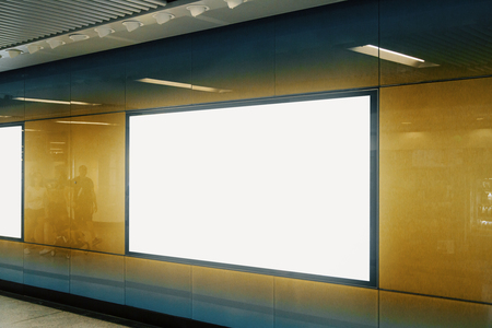 Side view of empty white subway billboard on orange wall. Advertisement and urban concept. Mock upの写真素材