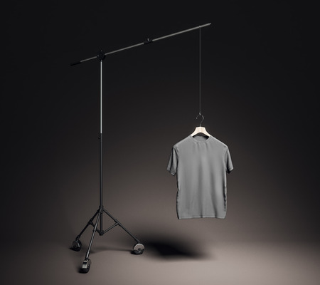 Empty gray t-shirt in photo studio with professional lighting equipment. Fashion, design and mockup concept. 3D Renderingの写真素材