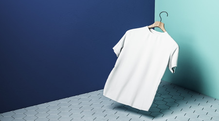 Abstract levitating white tshirt on hanger in concrete blue with shadow. Store, fabric, fashion and mockup concept. 3D Renderingの写真素材