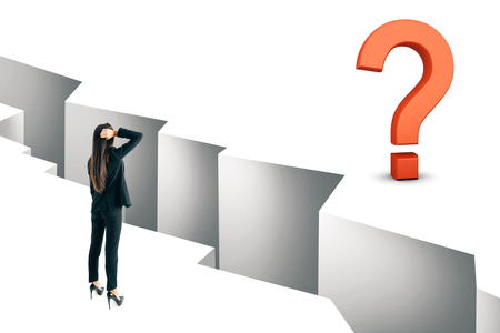 Thoughtful young businesswoman looking at gap with question mark. Challenge and solution concept.の写真素材