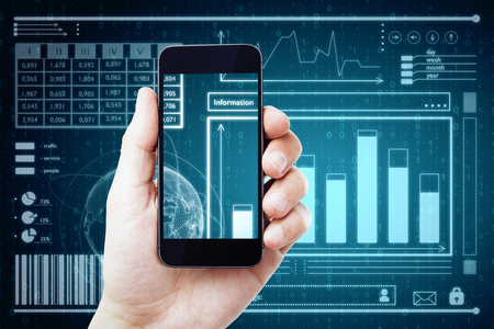 Close up of male hand holding smartphone with digital business interface. Fintech and technology concept. Double exposureの写真素材