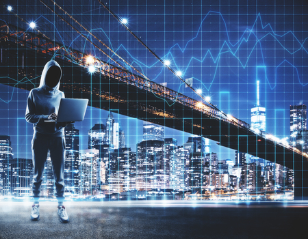Hacker using laptop on abstract illuminated night city background with forex chart grid. Malware and analysis concept. Double exposureの写真素材
