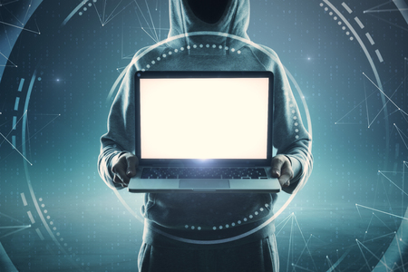 Hacker holding empty laptop on abstract digital background. Criminal and ad mockup conceptの写真素材