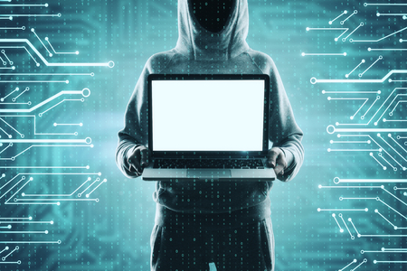 Hacker holding empty laptop on abstract digital circuit background. Malware and ad mockup conceptの写真素材