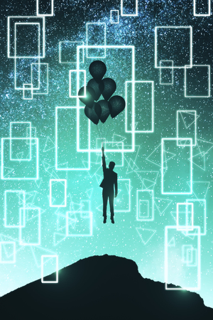 Backlit person with balloons and geometric pattern on hill standing on beautiful starry night sky space background. Freedom and approach conceptの写真素材