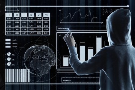 Hacker with financial interface on dark background. Malware and hacking conceptの写真素材