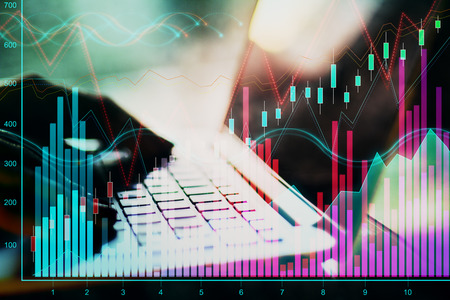 Close up of hands using laptop with forex chart on blurry background. Communication and analytics...