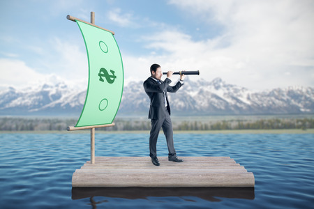 Businessman on money boat looking into the distance. Landscape background. Research and rich conceptの写真素材