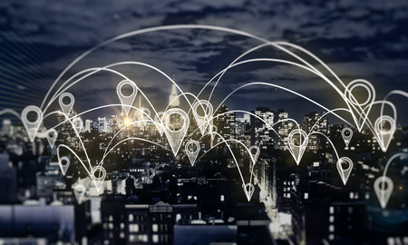 Glowing night city with map location pins. Social network and communication concept. Double exposureの写真素材