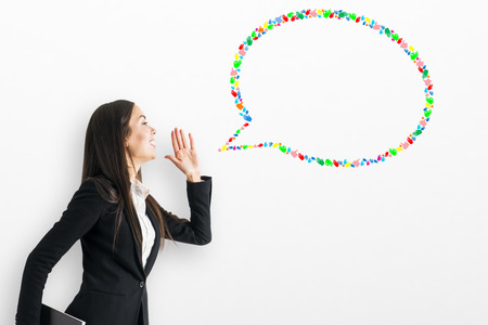 Portrait of thoughtful young woman with creative hand gesture speech bubble on white background. Social media, communication and network conceptの写真素材