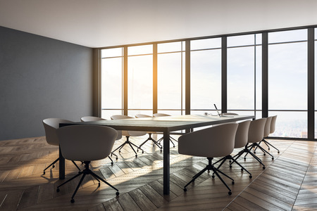 Stylish meeting room interior with panoramic city view, furniture, laptop on desktop and daylight. Toned image. 3D Renderingの写真素材