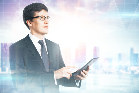 Side view of attractive young european businessman using cellphone on blurry city background. Network and success concept. Multiexposureの写真素材