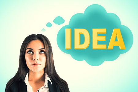Attractive young european businesswoman thinking about idea on blue background. Inspire and solution conceptの写真素材