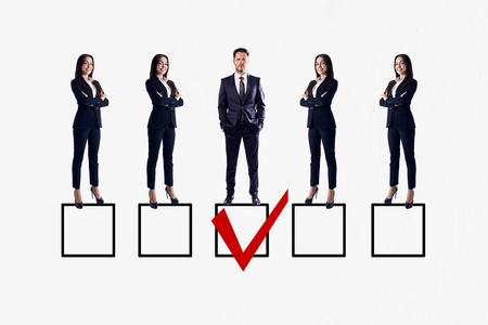 Row of businesswomen and man on white background with one red tick in box. Talent search and HR conceptの写真素材