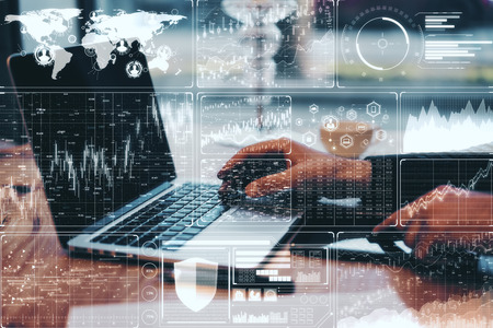 Close up of hands using computer with digital financial interface. Finance and innovation concept....
