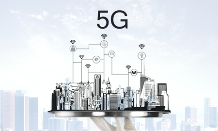 Hand holding tray with creative city drawing and 5G internet connections. Communication and network conceptの写真素材