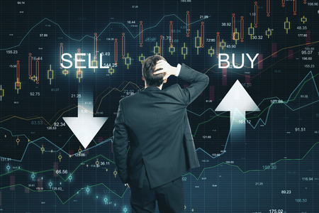 Back view of thoughtful businessman on creative buy sell forex chart background. Economy and finance conceptの写真素材