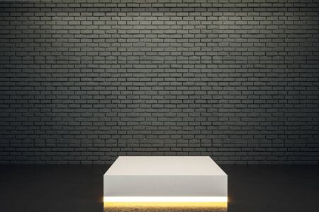Blank illuminated pedestal in interior with copy space on brick wall. Mock up, 3D Renderingの写真素材