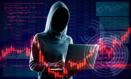 Hacker in hoodie holding laptop with glowing forex chart. Attack and invest concept. Multiexposureの写真素材