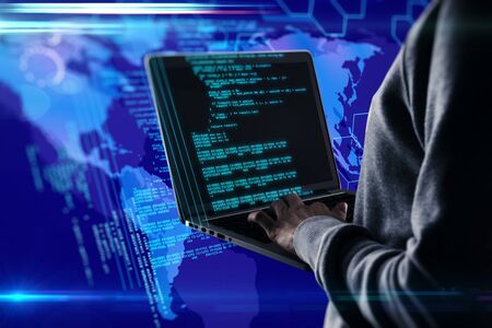 Hacker using laptop computer with html code and map. Hacking and programming concept. Multiexposure
