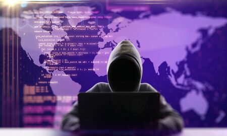 Hacker using laptop computer with html code and map. Malware and programming concept. Double...