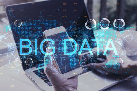 Hands using laptop and smartphone on abstract polygonal big data background. Technology and network concept. Multiexposureの写真素材