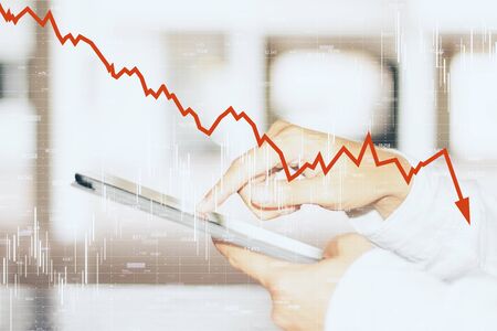 Close up and side view of hands using smartphone with downward red chart arrow. Decrease, internet...