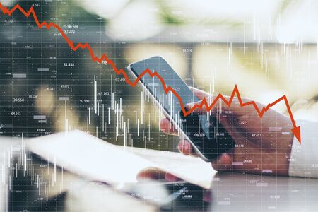 Close up and side view of hands using smartphone with downward red chart arrow. Decrease, internet...