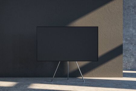 Modern interior with empty black canvas on tripod. Concrete wall background. Mock up, 3D Rendering