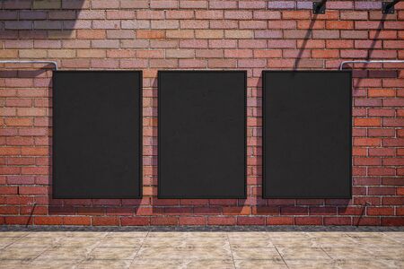 Front view of three empty black banners on outdoor red brick wall background. Mock up, 3D Renderingの写真素材