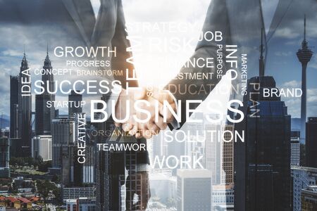 Positive thinking and teamwork concept. Businesspeople shaking hands on blurry Kuala Lumpur city background with words. Double exposureの写真素材