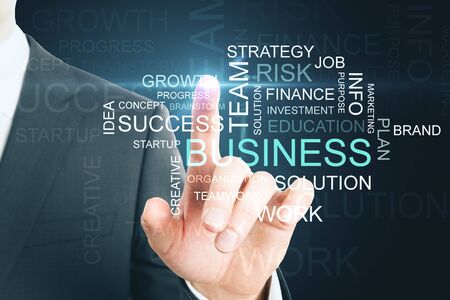 Positive thinking and motivation concept. Businessman hand pointing at words on dark background. Multiexposureの写真素材