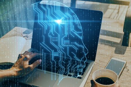 Close up of hands using laptop with abstract circuit head outline at cafe table background with coffee cup. AI and interface concept. Double exposureの写真素材
