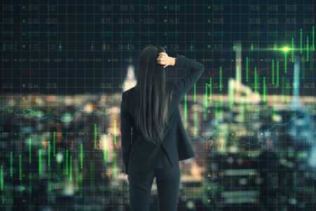 Growth concept with pensive businesswoman and digital forex chart screen with green graphs going up. Double exposureの写真素材